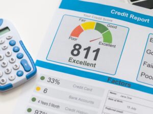 Upper left corner of a credit report showing the person’s credit score. A large number 811 in black letters with smaller text below saying Excellent. There’s a graphic of a meter above going poor to excellent, with the needle pointing more towards excellent.