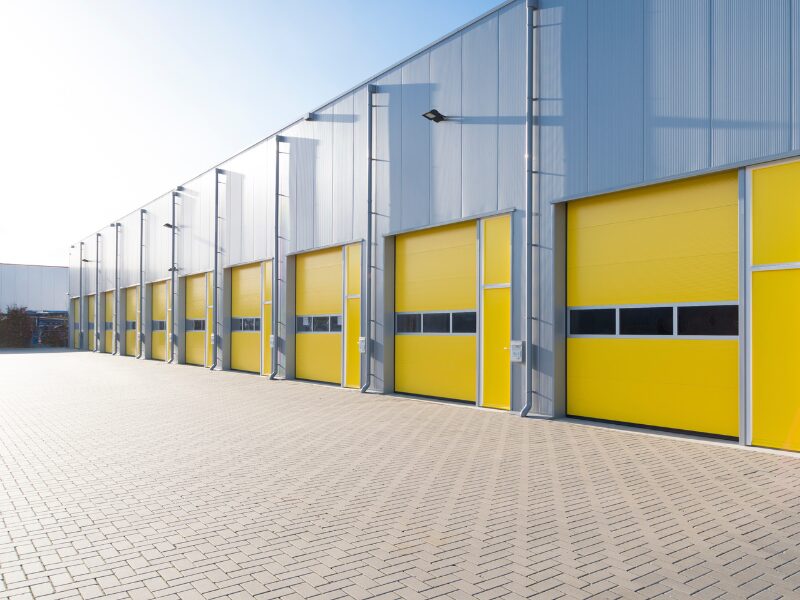 Exterior of a modern gray and yellow commercial warehouse