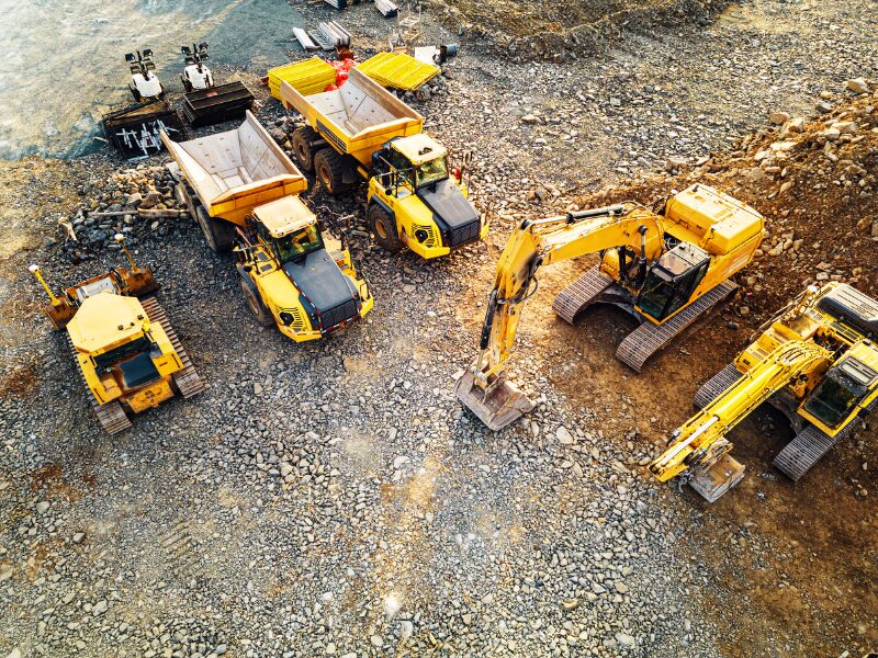 Bird’s eye view of several yellow heavy equipment for construction and industrial use