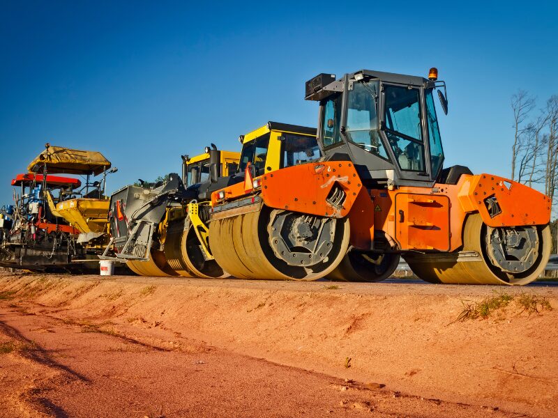 Row of heavy machinery, road roller compressor machines