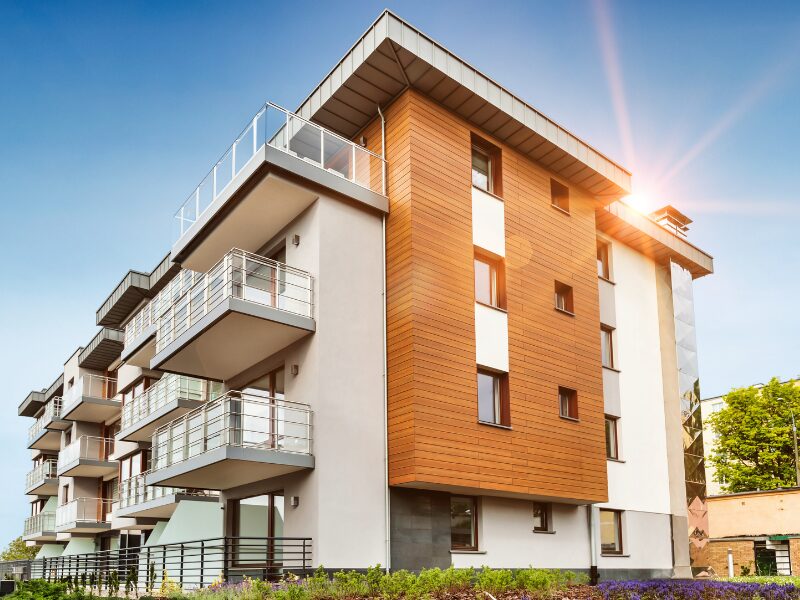 Finished multi-building low-rise residential development project with a modern design, sunlight peeking through the top of the buildings