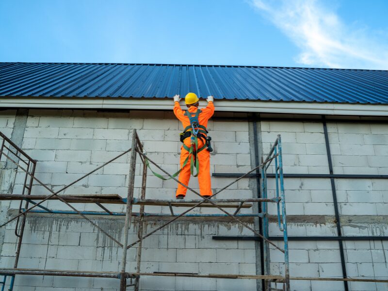 Worker building the roof of a commercial property