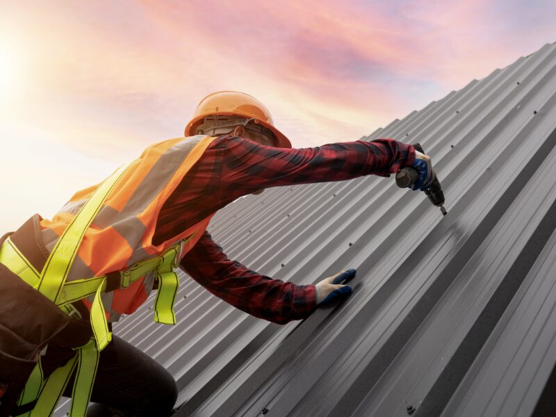 Construction or maintenance worker doing work on the roof of a commercial property