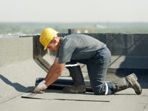 Labourer working on the rooftop of a commercial property