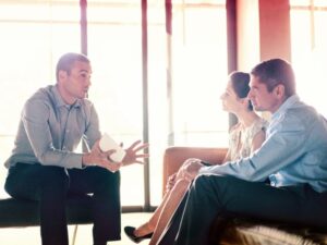 A mortgage broker explains tax debt loans to business owners during a consultation meeting