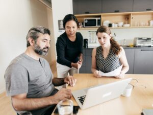A mortgage broker discusses tax debt loan options to two business owners struggling with ATO tax debt