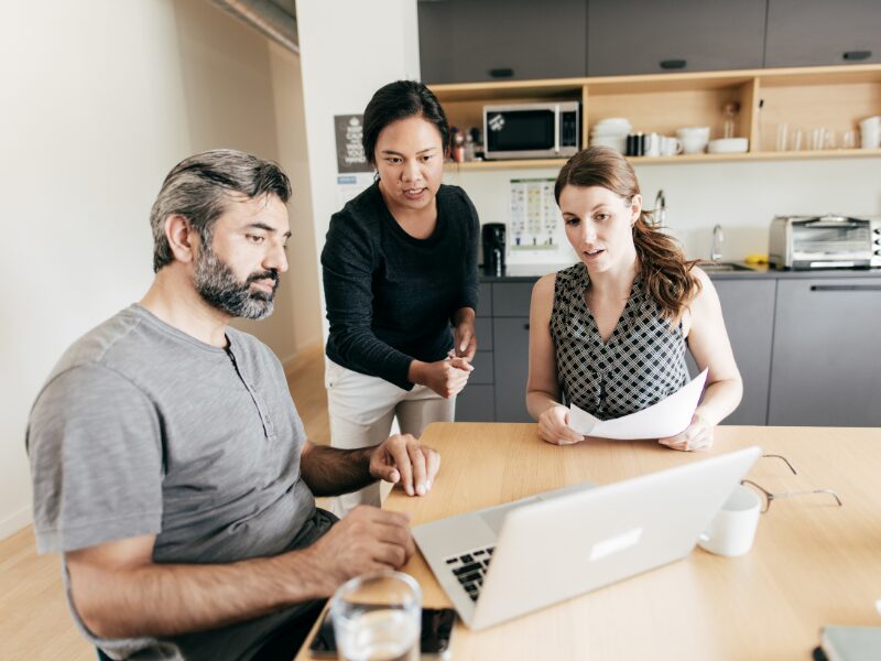 A mortgage broker discusses tax debt loan options to two business owners struggling with ATO tax debt