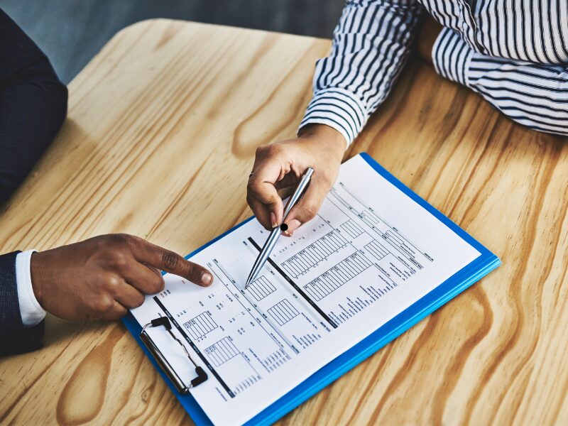A mortgage broker and a self-employed borrower go through the different requirements for a home loan