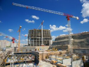 An ongoing commercial property development project, a building under construction set against a bright blue sky