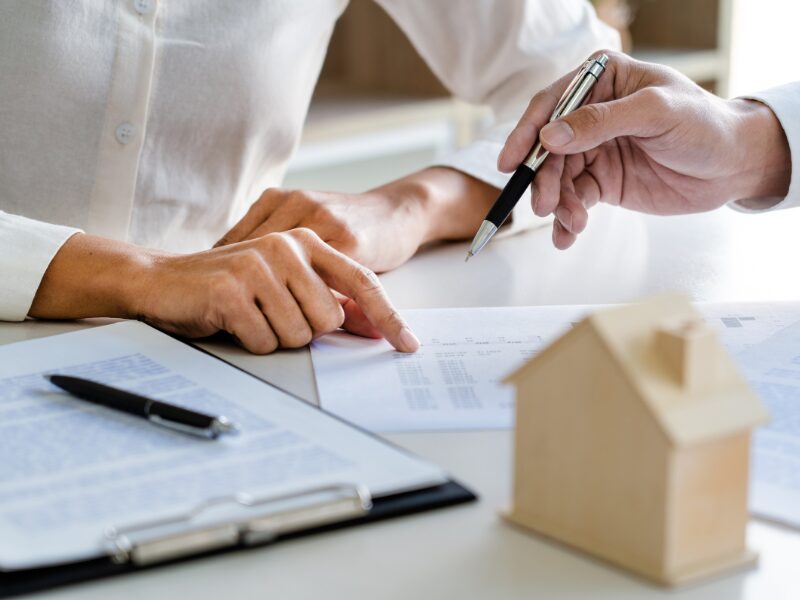 Cropped photo of a mortgage broker or lender discussing loan structures with a self-employed borrower