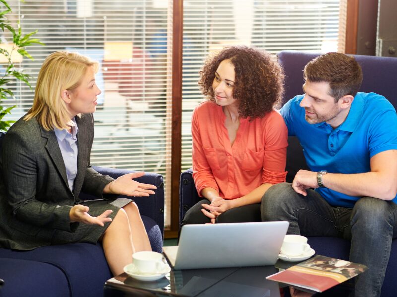 Two PAYG home buyers meet with a mortgage broker to discuss their loan options