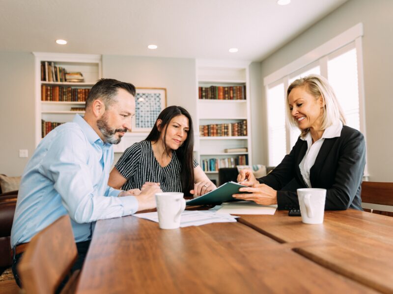 A lending expert presents refinancing options to a business-owning couple