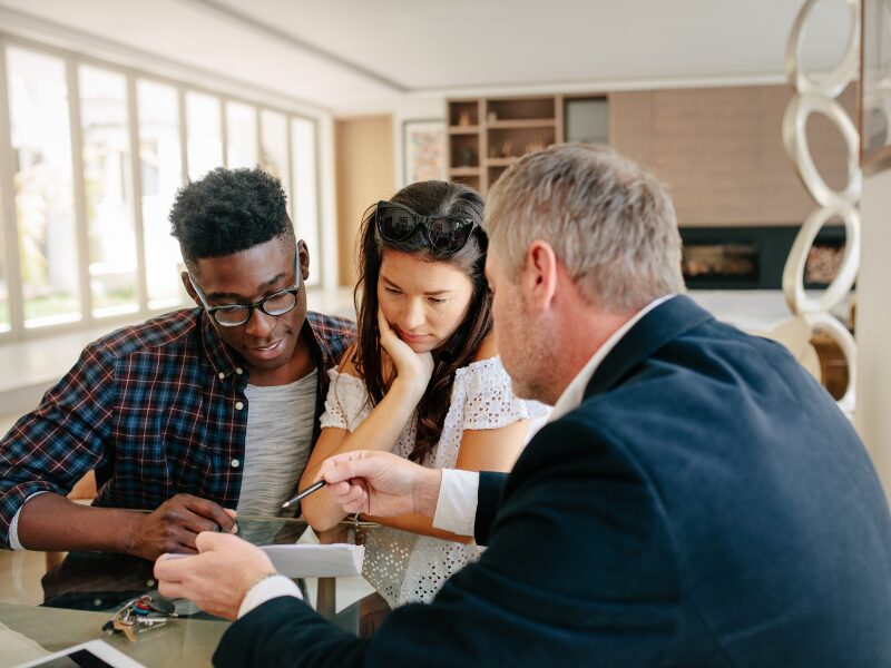 A mortgage broker discusses the documents needed for a self employed home loan with two clients