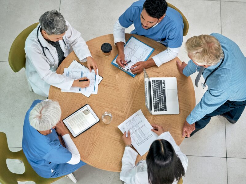 Group of allied health professionals seated at a round table