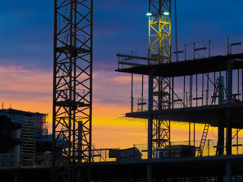 Silhouette of an ongoing construction of a building against the dusk sky
