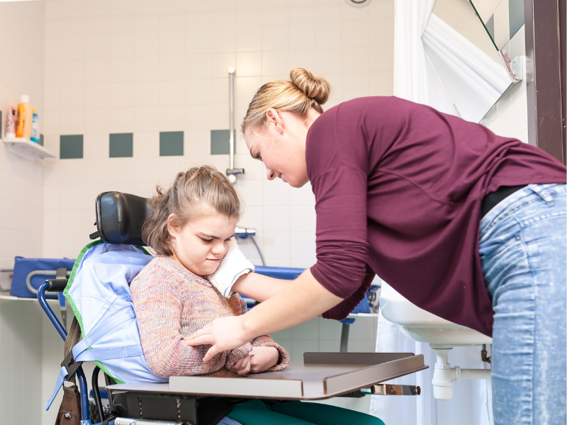 NDIS worker assists a child with disability