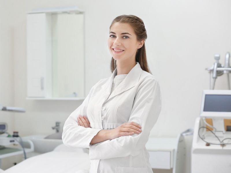 A physician at an allied health clinic posing for a photo with her arms crossed