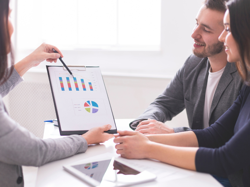 A financial advisor discusses a document with clients