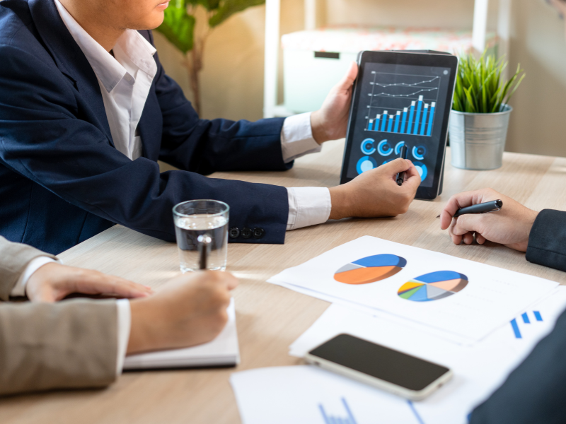 Cropped photo of a financial advisor using an electronic tablet to present to clients