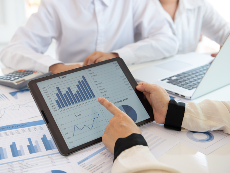 Cropped photo of a financial advisor using a tablet during a meeting with clients