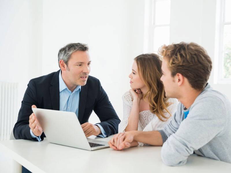 A mortgage broker or lender meets with a self-employed couple looking for a low doc home loan