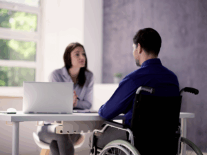 A man in a wheelchair during consultation with an NDIS worker