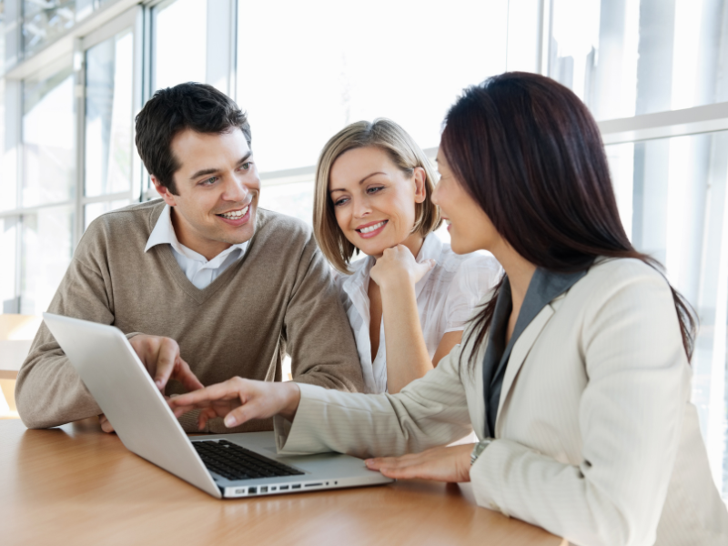 A couple meets with a mortgage broker or a private lender to talk about their private loan options