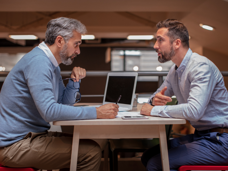A business owner undergoing SBR talking to a mortgage broker about their financing options