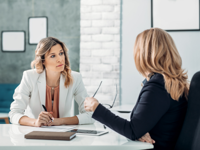 A client meeting between a mortgage broker and a business owner, discussing commercial line of credit options