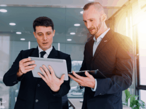 A mortgage broker presents options to a business owner, choosing between progress claims finance vs invoice factoring
