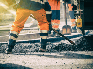 Cropped photo of a construction worker shovelling cement