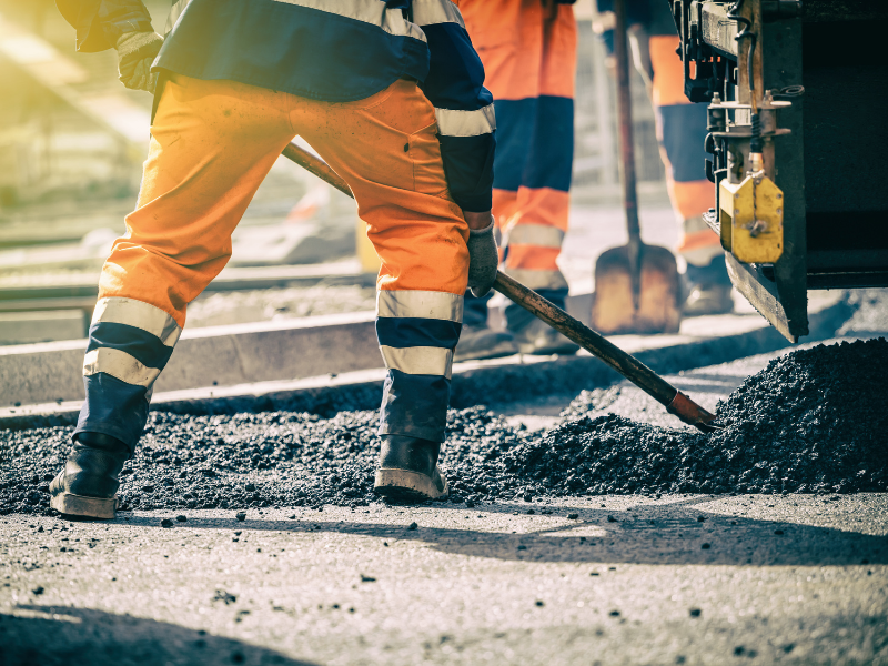 Cropped photo of a construction worker shovelling cement