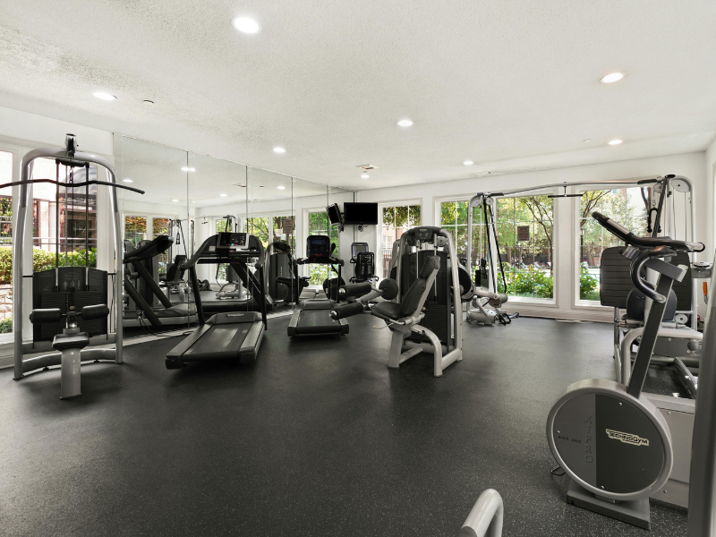 An empty fully equipped gym with equipment and rubber floors