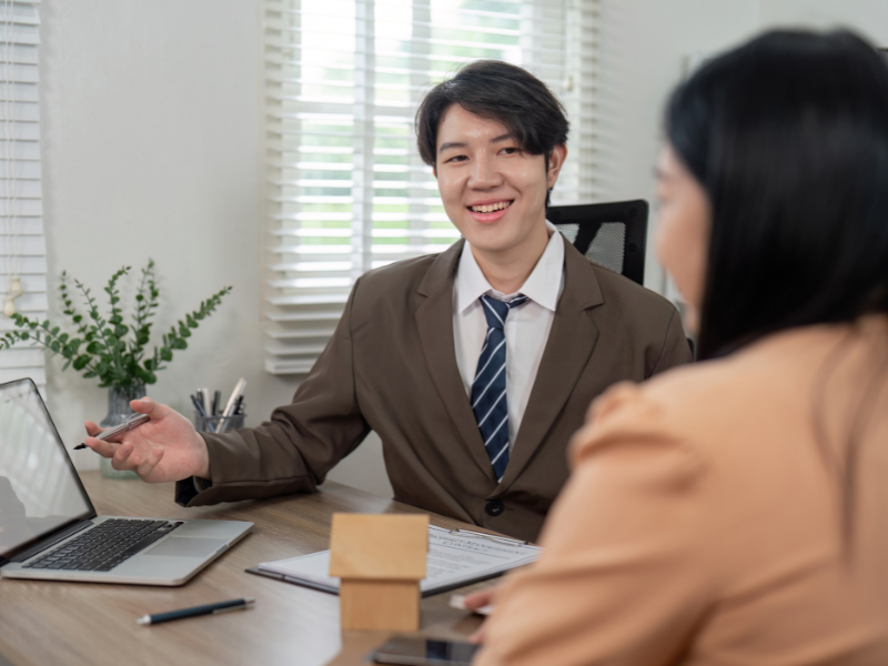 A mortgage broker presents tax debt loan options to a business owner with property available to use as security