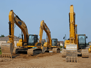Three large yellow excavators for construction, large construction heavy equipment