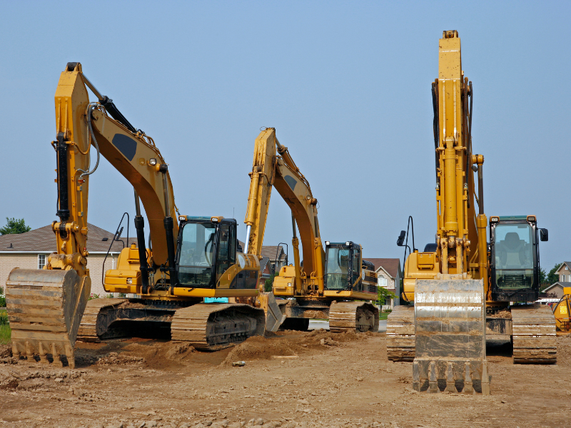 Three large yellow excavators for construction, large construction heavy equipment