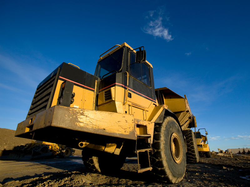 Large yellow equipment for construction, heavy equipment, deep blue sky in the background