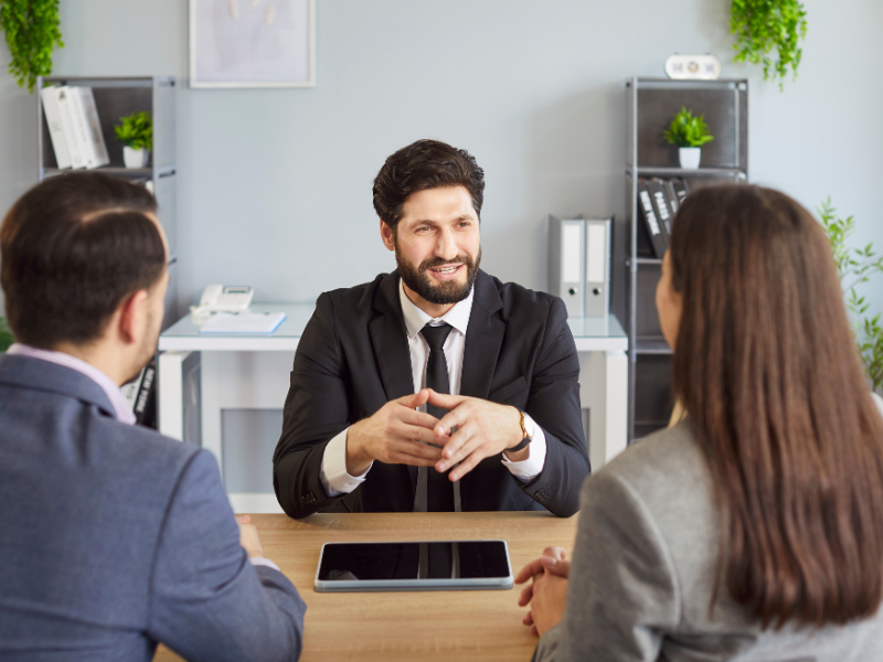 A mortgage broker discusses refinancing options with business owners