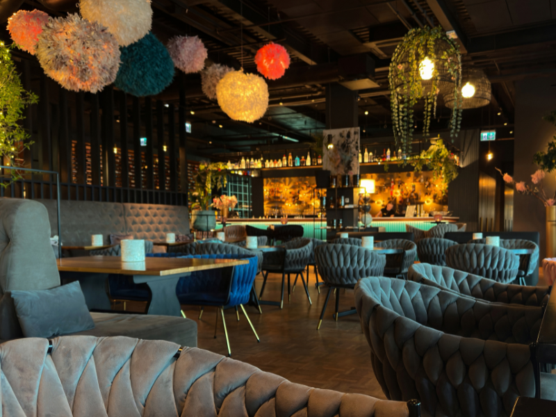 Dimly lit bar and bistro interiors with comfortable seating and vibrant decor