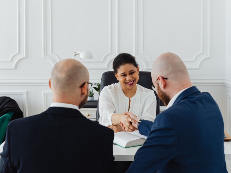 Mortgage broker and business owner shakes hands, agreeing on a bad credit emergency loan solution