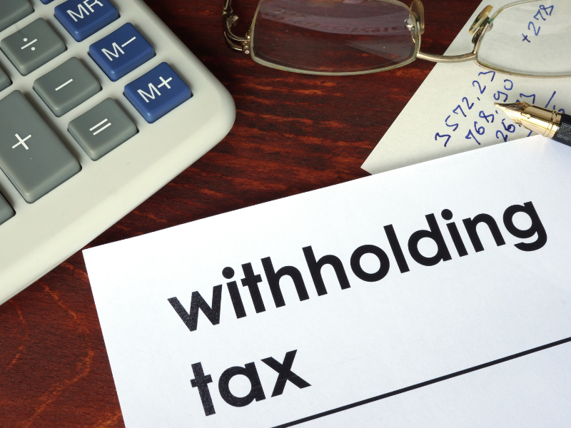 A corner of a document with large bold text saying withholding taxv