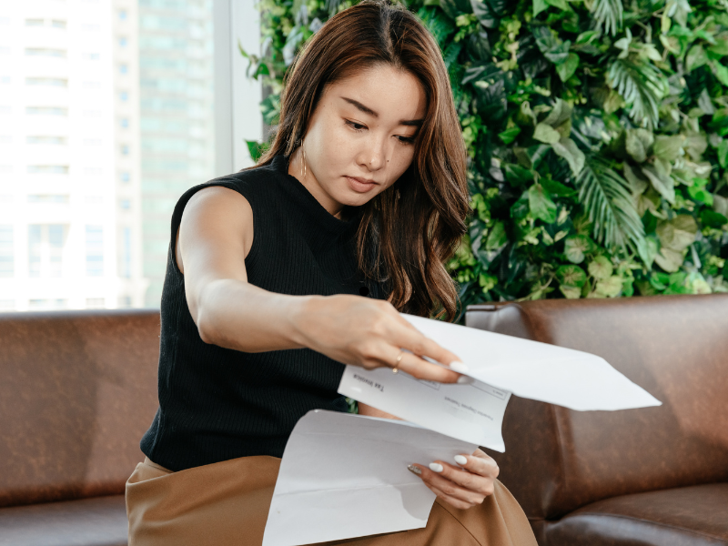 A woman reads documents from the ATO