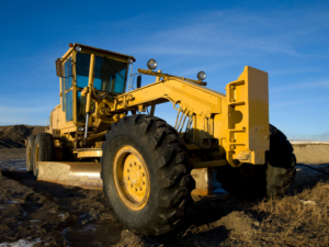 Yellow construction equipment with blue skies in the background