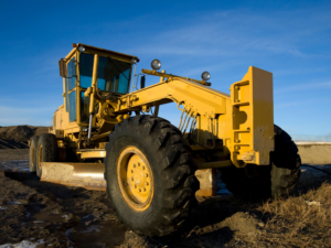 Yellow construction equipment with blue skies in the background