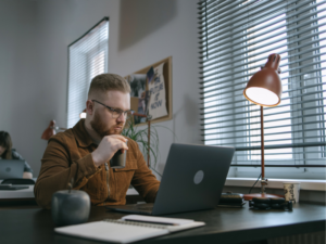 Business owner seated at a desk working on a laptop, lodging BAS online through the ATO website