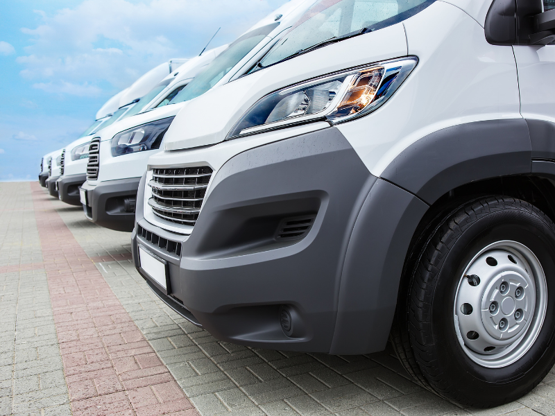 A fleet of utility vans parked side by side