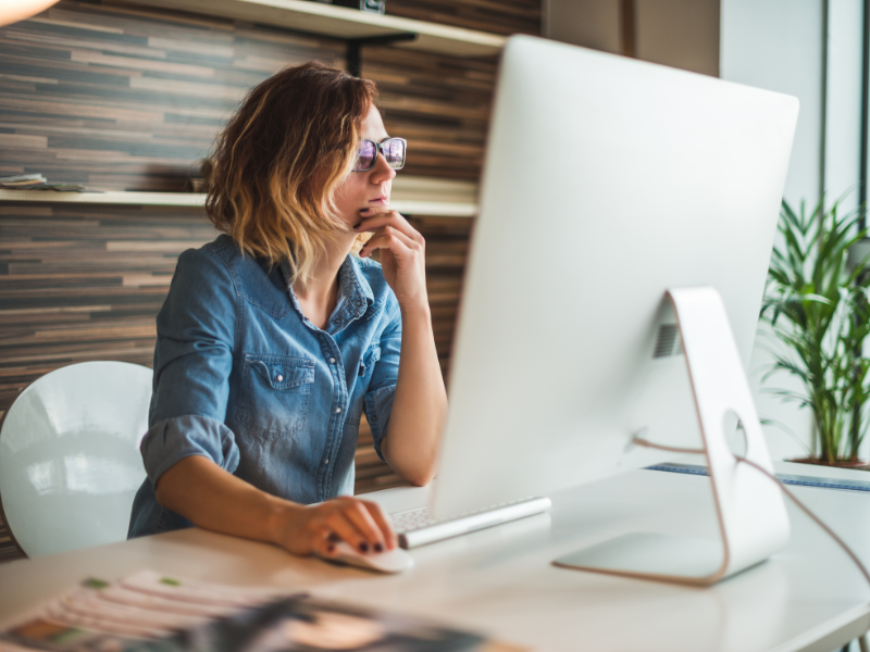Woman using computer, business owner comparing business line of credit providers online