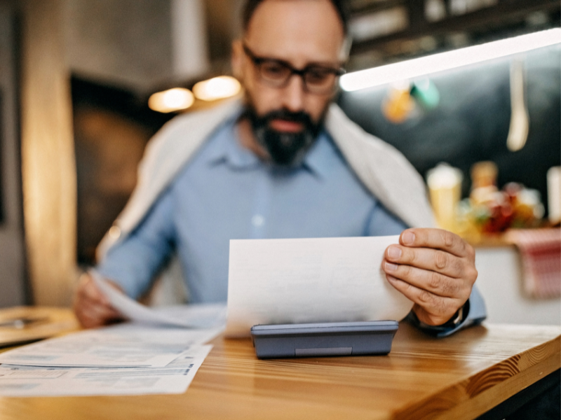 Business owner reading documents from his insurance provider