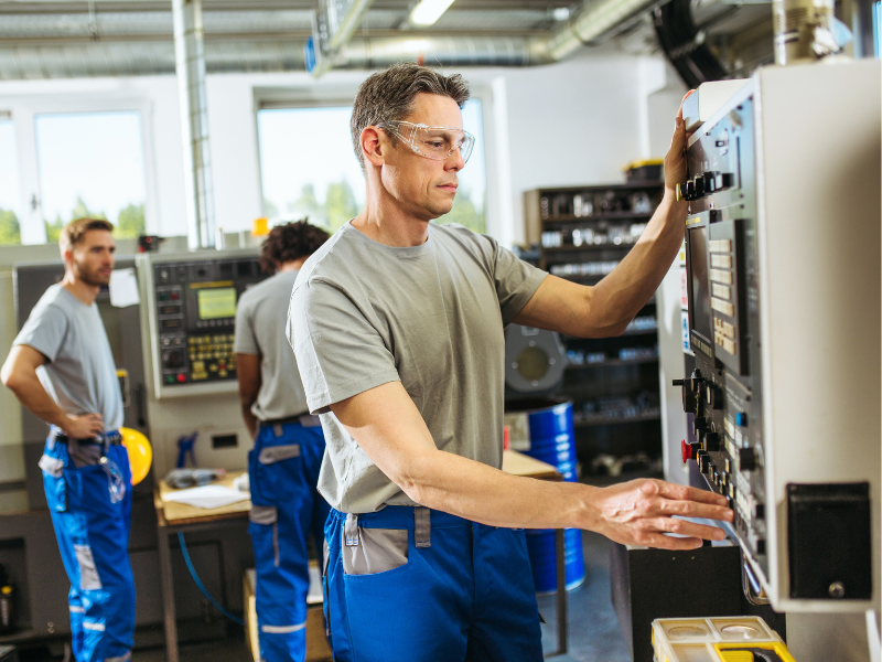 A manufacturing machine operator using equipment