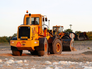Brand new yellow construction equipment at a construction site